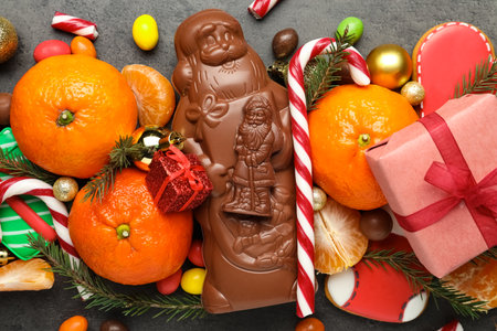 Flat lay composition with chocolate Santa Claus candies on table, closeupの写真素材