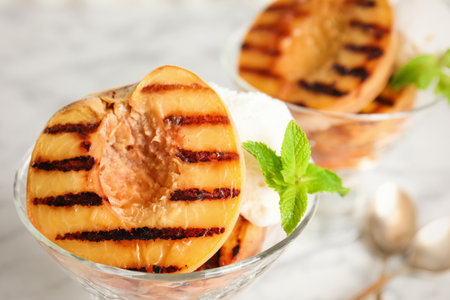 Delicious grilled peach with ice cream and mint, closeupの写真素材