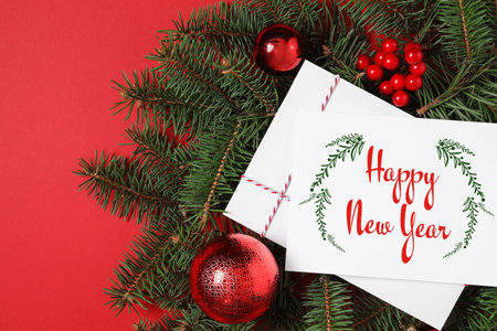 Greeting card with text Happy New Year and Christmas decor on red background, flat layの写真素材
