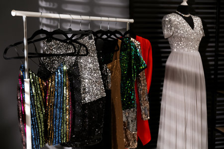 Rack with collection of festive beautiful clothes indoorsの写真素材