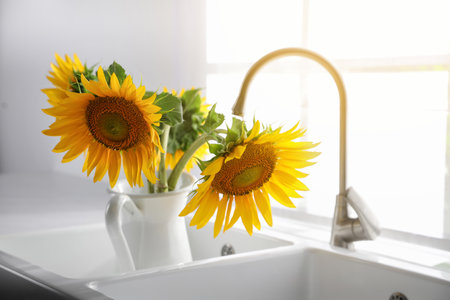 Bouquet of beautiful sunflowers in sink at homeの写真素材