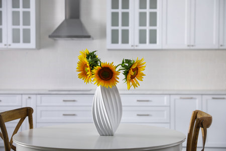 Bouquet of beautiful sunflowers on table in kitchenの写真素材