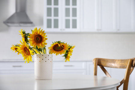 Bouquet of beautiful sunflowers on table in kitchenの写真素材