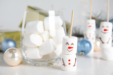 Funny snowman made of marshmallows on white tableの写真素材
