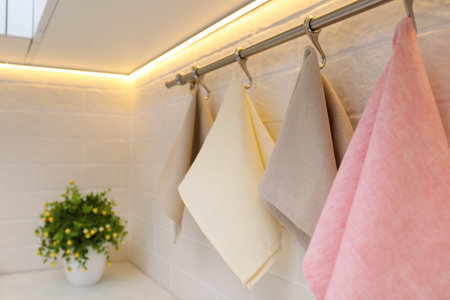 Clean kitchen towels hanging on wall indoors, closeupの写真素材