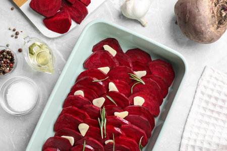 Flat lay composition with raw beetroot slices on light marble tableの写真素材