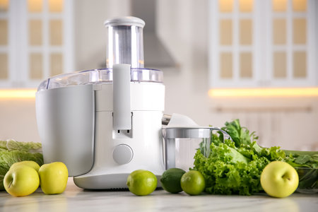 Modern juicer, fresh vegetables and fruits on table in kitchenの写真素材