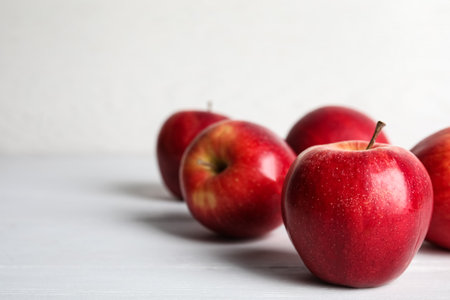 Ripe red apples on white wooden table. Space for textの写真素材