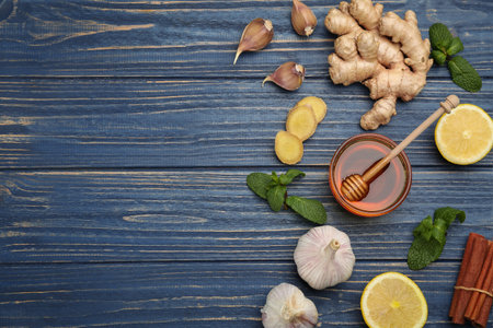 Flat lay composition with fresh products on blue wooden table, space for text. natural antibioticsの写真素材
