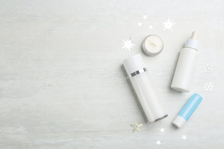 Flat lay composition with different cosmetic products on light table, space for text. winter careの写真素材
