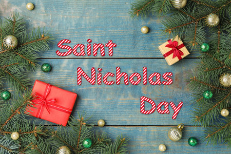 Saint Nicholas Day. Flat lay composition with fir branches and gifts on blue wooden backgroundの写真素材