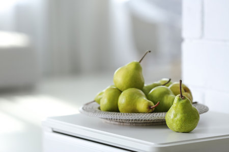 Fresh ripe pears on white table in room. Space for textの写真素材