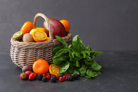 Assortment of fresh exotic fruits and berries on gray table. Space for textの写真素材