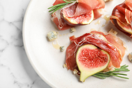Delicious ripe figs and prosciutto served on white marble table, closeupの写真素材