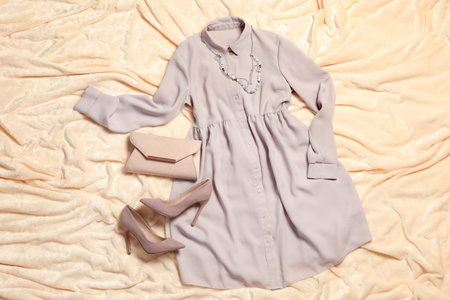Flat lay composition with stylish gray dress on beige blanketの写真素材