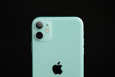 MYKOLAIV, UKRAINE - JULY 9, 2020: New modern Iphone 11 Green on black background, closeup