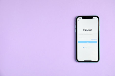 MYKOLAIV, UKRAINE - JULY 10, 2020: Iphone 11 with Instagram app on violet background, top view. Space for textのeditorial素材