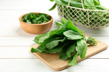 Fresh green sorrel leaves on white wooden table, closeupの写真素材
