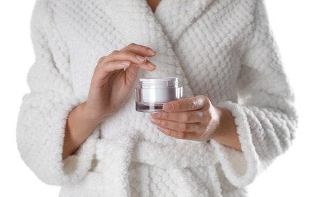 Woman with jar of moisturizing cream on white background, closeupの写真素材