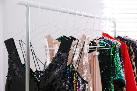 Stylish party dresses on rack indoors, closeupの写真素材