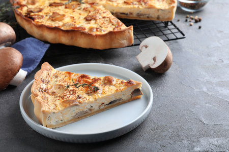 Delicious pie with mushrooms and cheese served on gray tableの写真素材