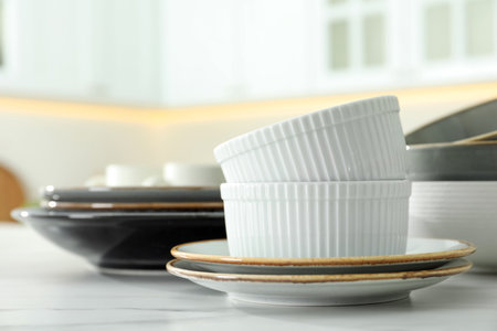 Set of ceramic tableware on white table in kitchen, closeupの写真素材