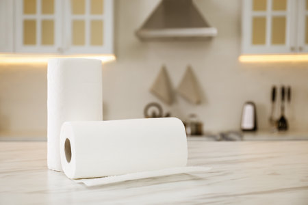 Rolls of paper towels on white table in kitchenの写真素材