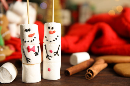 Funny snowmen made of marshmallows on wooden table, closeup. Space for textの写真素材