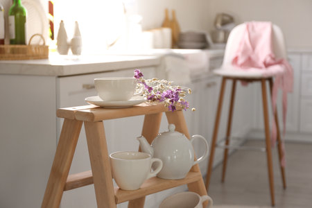 Decorative ladder with different dishware in the kitchen. Idea for interior designの写真素材
