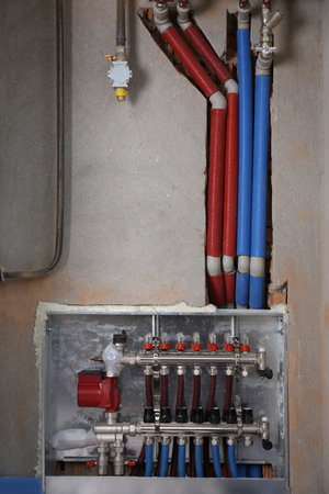 underfloor heating system. Manifold with pipes in buildingの写真素材
