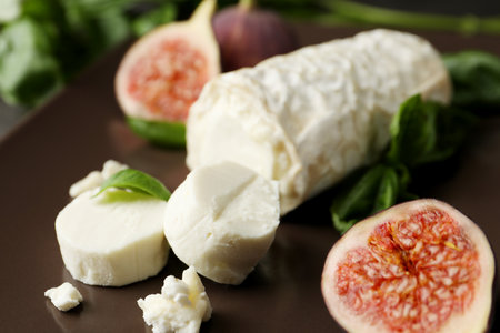 Delicious goat cheese with figs and basil on plate, closeupの写真素材