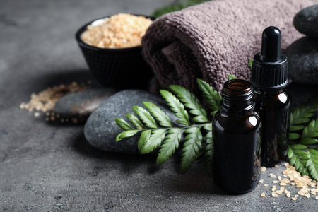 Spa composition with aroma oil on gray table, space for textの写真素材