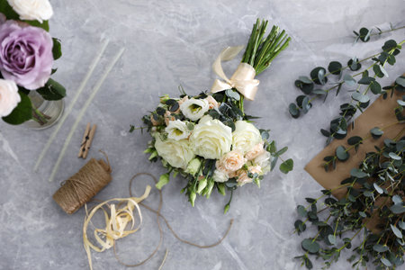 Beautiful wedding bouquet on light gray marble table, flat layの写真素材