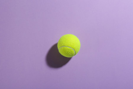 Tennis ball on blue background, top view. sports equipmentの写真素材
