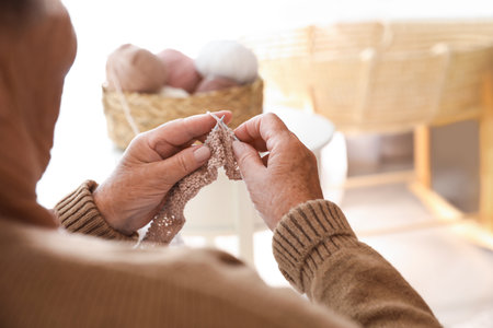 Elderly woman knitting at home, closeup. creative hobbyの写真素材