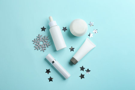 Flat lay composition with different cosmetic products on turquoise background. winter careの写真素材