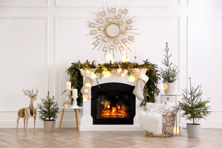 Stylish room interior with fireplace and beautiful Christmas decorの写真素材