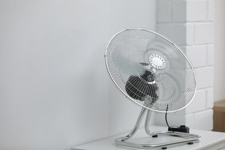 Modern electric fan on white table indoors. Space for textの写真素材