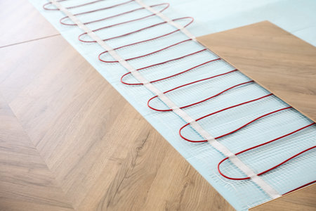 Installation of modern underfloor trace heating system indoors