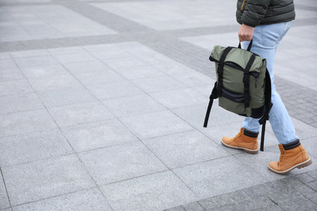 Male tourist with travel backpack on city street, closeup. urban tripの写真素材