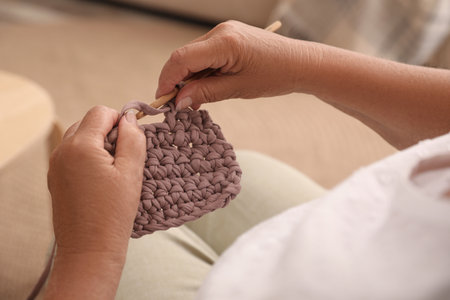 Elderly woman knitting at home, closeup. creative hobbyの写真素材