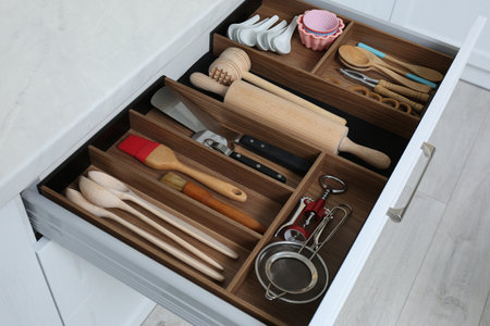Open drawer with utensil set indoors. Order in kitchenの写真素材