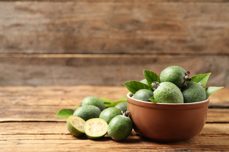 Fresh green feijoa fruits on wooden table, space for textの写真素材