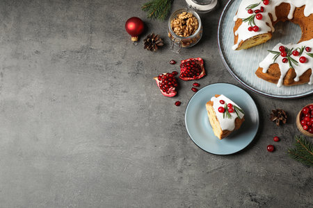 Flat lay composition with traditional homemade Christmas cake on gray table, space for textの写真素材