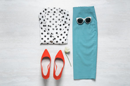 Stylish women's outfit on white wooden background, flat layの写真素材