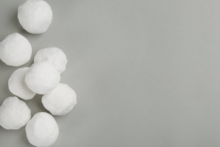 Snowballs on gray background, flat lay. Space for textの写真素材