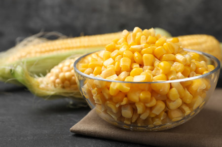 Bowl of preserved corn on gray table, closeupの写真素材