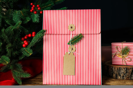 Beautifully decorated Christmas present on wooden tableの写真素材