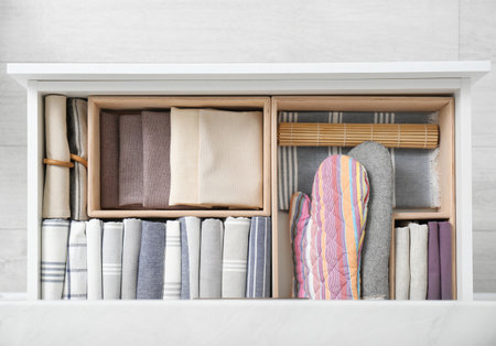 Open drawer with different textiles in kitchen, top viewの写真素材