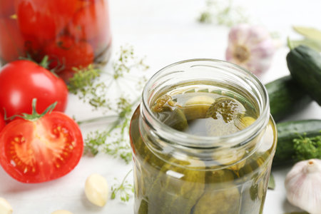 Glass jar of pickled cucumbers on table, closeup. Space for textの写真素材